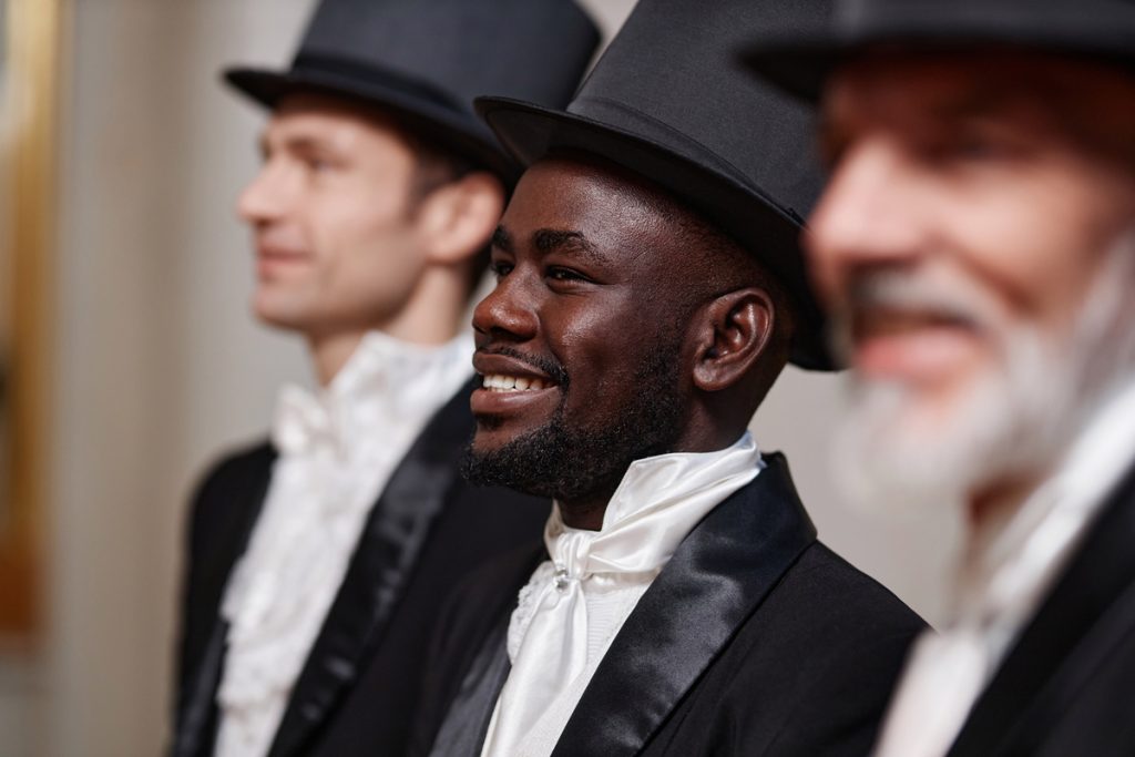 Smiling Black Gentleman Wearing Top Hat and Tuxedo in Row